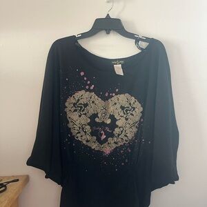 Baby phat shirt with wide sleeve and tightened material at the bottom.